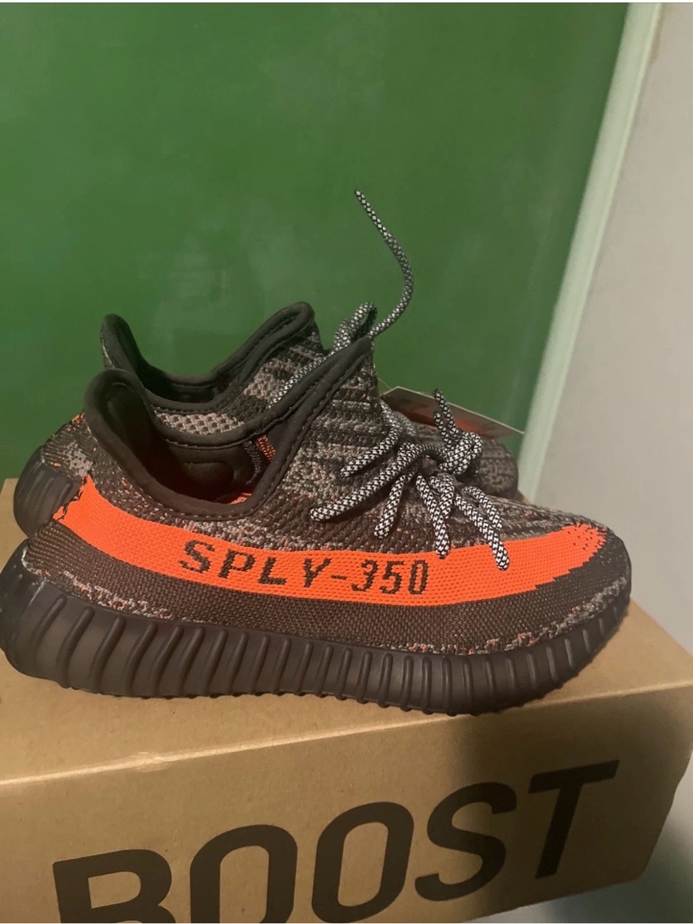 adidas women’s Yeezys 350 Knit Sneaker in Gray with Orange Stripe